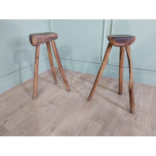 611 - Pair of vintage rustic hard wood three legged stools {80 cm H x 46 cm W x 37 cm D}.