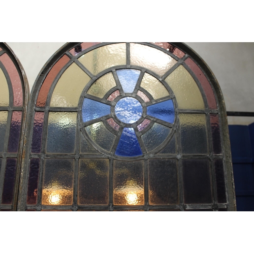 627 - Pair of stained glass and wrought iron leaded arched windows with opening to bottom {Each: H 228cm x... 