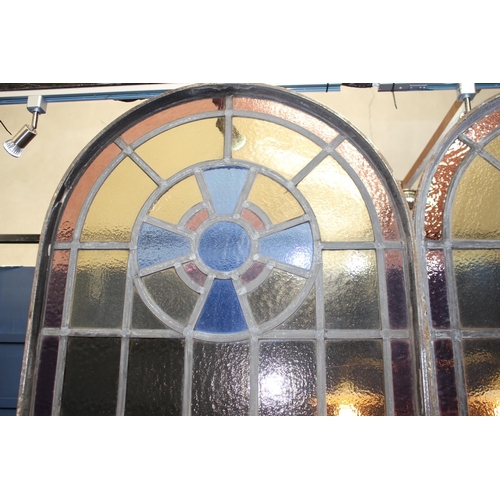 627 - Pair of stained glass and wrought iron leaded arched windows with opening to bottom {Each: H 228cm x... 