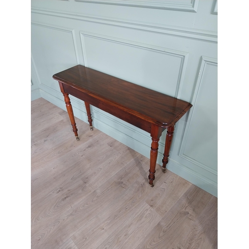 636 - Good quality 19th C. mahogany side table raised on turned legs and brass castors {77 cm H x 122 cm W... 