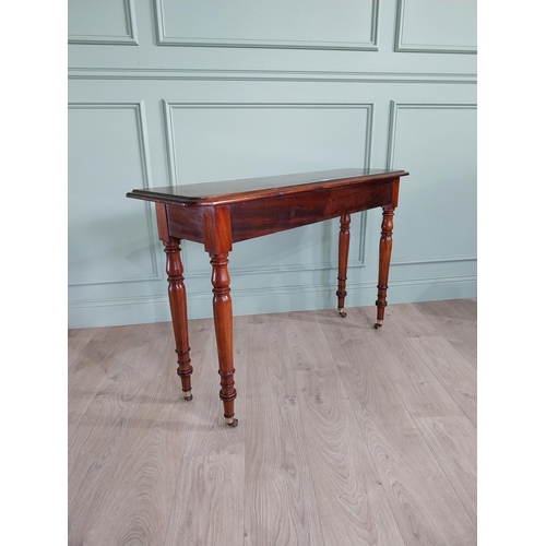 636 - Good quality 19th C. mahogany side table raised on turned legs and brass castors {77 cm H x 122 cm W... 