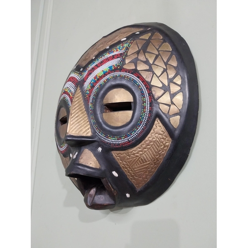 640 - Carved hardwood and embossed brass African tribal mask {41 cm H x 40 cm W x 10 cm D}.