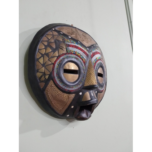 640 - Carved hardwood and embossed brass African tribal mask {41 cm H x 40 cm W x 10 cm D}.