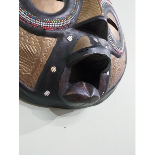 640 - Carved hardwood and embossed brass African tribal mask {41 cm H x 40 cm W x 10 cm D}.