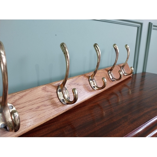 649 - Good quality set of brass coat hangers mounted on oak plaque {16 cm H x 90 cm W x 9 cm D}.