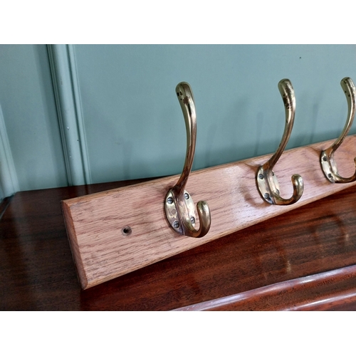 649 - Good quality set of brass coat hangers mounted on oak plaque {16 cm H x 90 cm W x 9 cm D}.