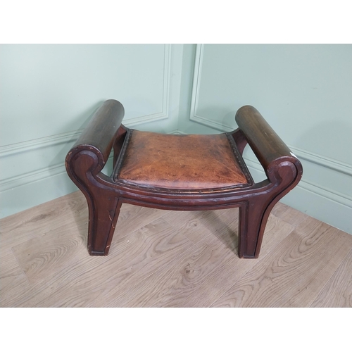 668 - Mahogany foot stool with leather upholstered seat in the lyre form {41 cm H x 40 cm W x 64 cm D}.