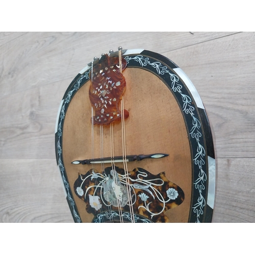 681 - Mandolin with mother of pearl inlaid in leather case.