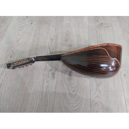 681 - Mandolin with mother of pearl inlaid in leather case.