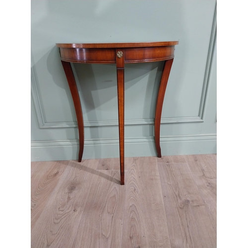 682 - Burr walnut demi-lune side table raised on tapered legs {70 cm H x 61 cm W x 30 cm D}.