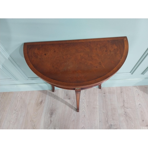 682 - Burr walnut demi-lune side table raised on tapered legs {70 cm H x 61 cm W x 30 cm D}.