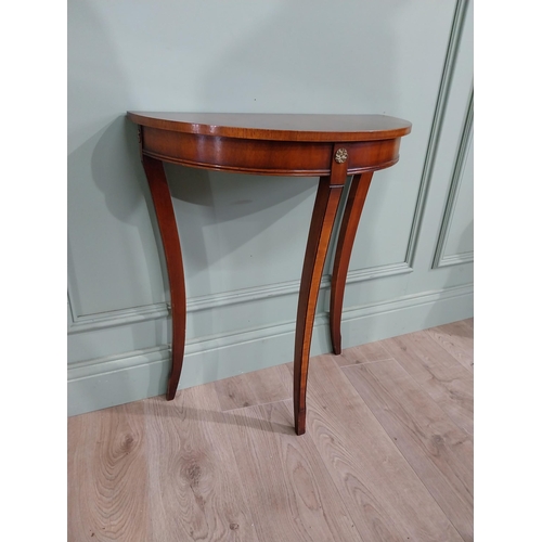 682 - Burr walnut demi-lune side table raised on tapered legs {70 cm H x 61 cm W x 30 cm D}.