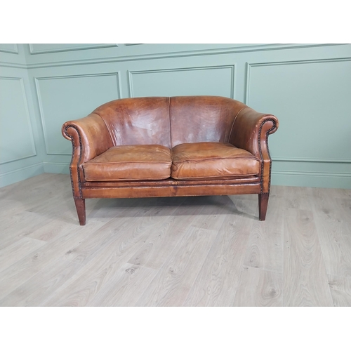 71 - French hand-dyed leather two seater upholstered sofa raised on square tapered legs {82 cm H x 143 cm... 