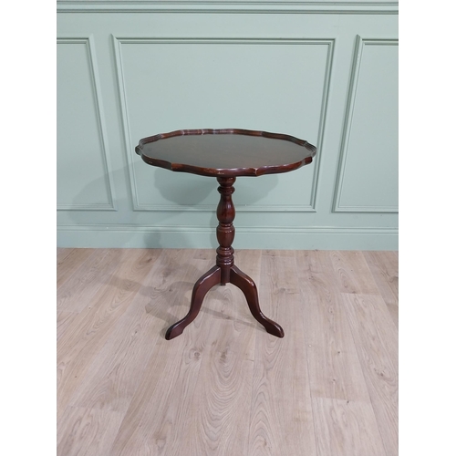 711 - Late 19th. C. mahogany wine table with pie crust top above a turned spiral column and three out swep... 