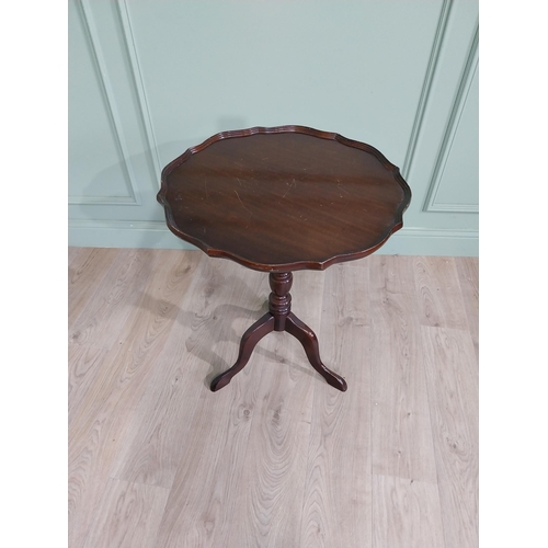 711 - Late 19th. C. mahogany wine table with pie crust top above a turned spiral column and three out swep... 