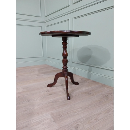 711 - Late 19th. C. mahogany wine table with pie crust top above a turned spiral column and three out swep... 