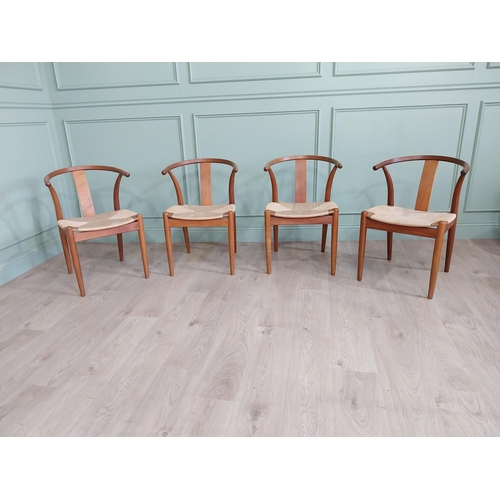 740 - Set of four Danish teak dining room armchairs with rush seats raised on tapered legs {76 cm H x 54 c... 