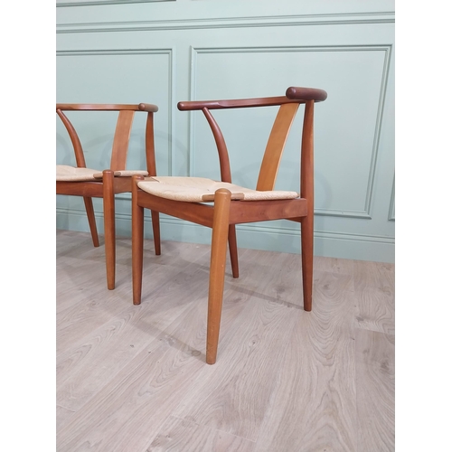 740 - Set of four Danish teak dining room armchairs with rush seats raised on tapered legs {76 cm H x 54 c... 