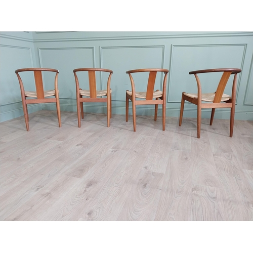 740 - Set of four Danish teak dining room armchairs with rush seats raised on tapered legs {76 cm H x 54 c... 