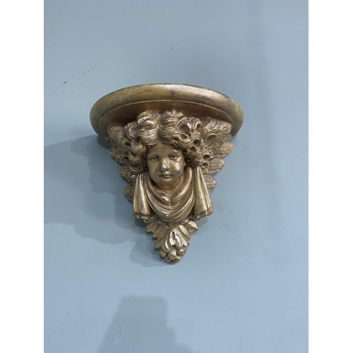 75 - Pair of gilded resin wall sconces decorated with winged cherubs {30 cm H x 32 cm W x 20 cm D}.