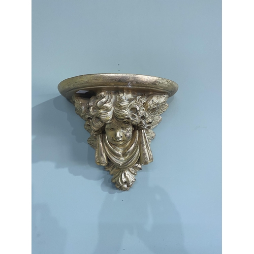 75 - Pair of gilded resin wall sconces decorated with winged cherubs {30 cm H x 32 cm W x 20 cm D}.