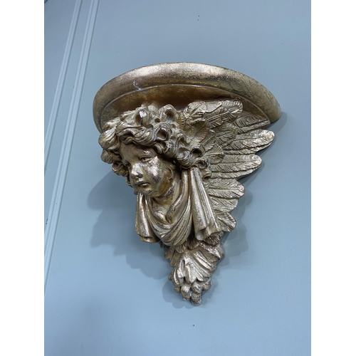 75 - Pair of gilded resin wall sconces decorated with winged cherubs {30 cm H x 32 cm W x 20 cm D}.