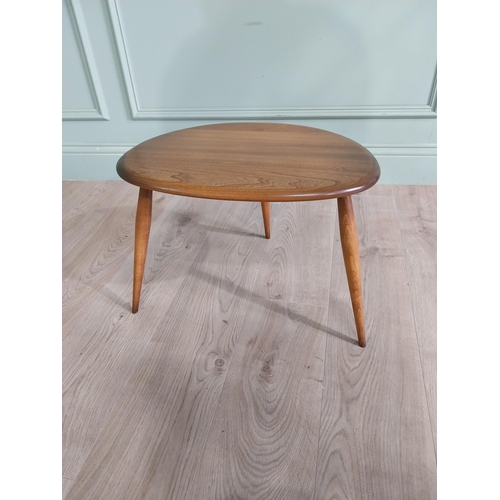 761 - Ercol oak lamp table raised on three splayed legs {36 cm H x 56 cm W x 38 cm D}.