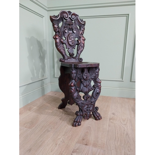 780 - Pair of 19th C.  carved walnut armorial hall chairs  {100 cm H x 40 cm W x 40 cm D}.