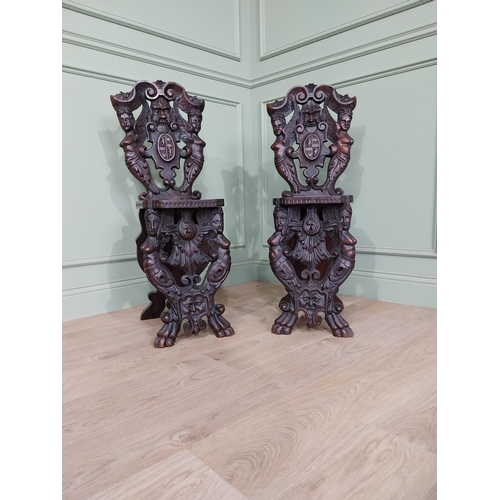 780 - Pair of 19th C.  carved walnut armorial hall chairs  {100 cm H x 40 cm W x 40 cm D}.