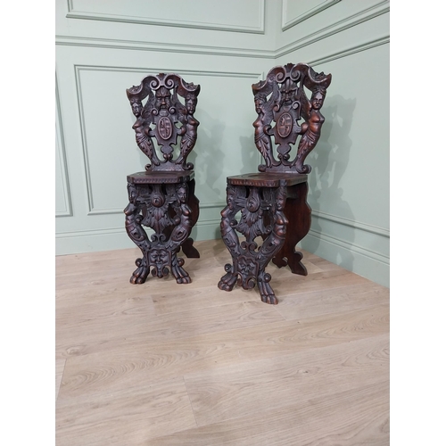 780 - Pair of 19th C.  carved walnut armorial hall chairs  {100 cm H x 40 cm W x 40 cm D}.