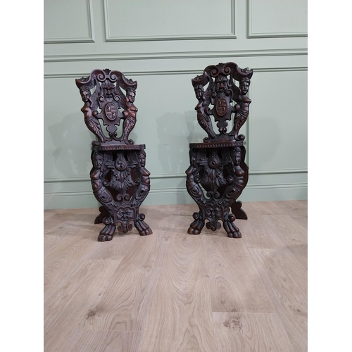 780 - Pair of 19th C.  carved walnut armorial hall chairs  {100 cm H x 40 cm W x 40 cm D}.