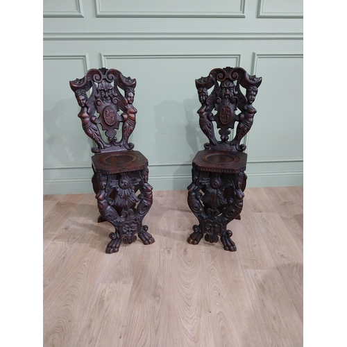 780 - Pair of 19th C.  carved walnut armorial hall chairs  {100 cm H x 40 cm W x 40 cm D}.