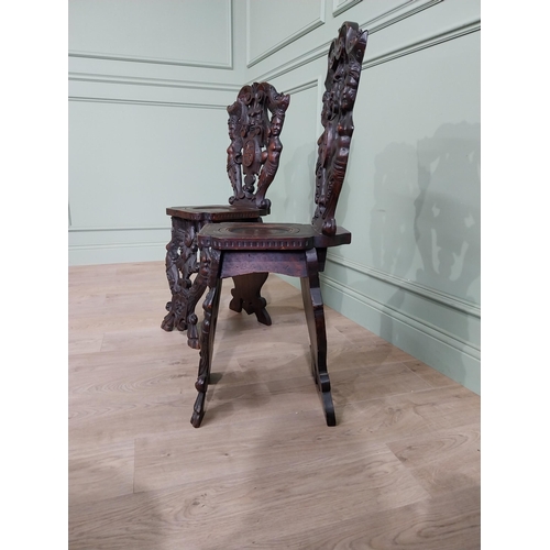 780 - Pair of 19th C.  carved walnut armorial hall chairs  {100 cm H x 40 cm W x 40 cm D}.