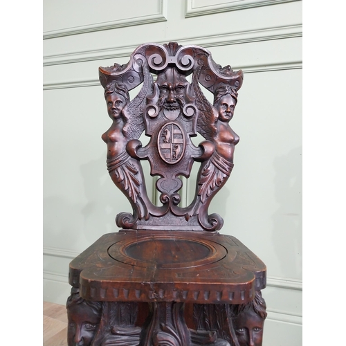 780 - Pair of 19th C.  carved walnut armorial hall chairs  {100 cm H x 40 cm W x 40 cm D}.