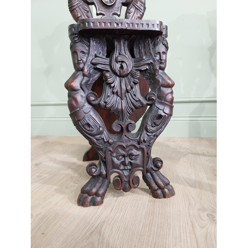 780 - Pair of 19th C.  carved walnut armorial hall chairs  {100 cm H x 40 cm W x 40 cm D}.