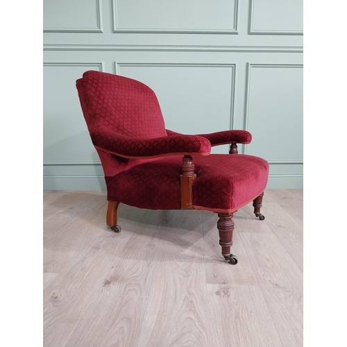 801 - 19th C. mahogany upholstered easy chair raised on turned legs and brass castors in the Howard and so... 