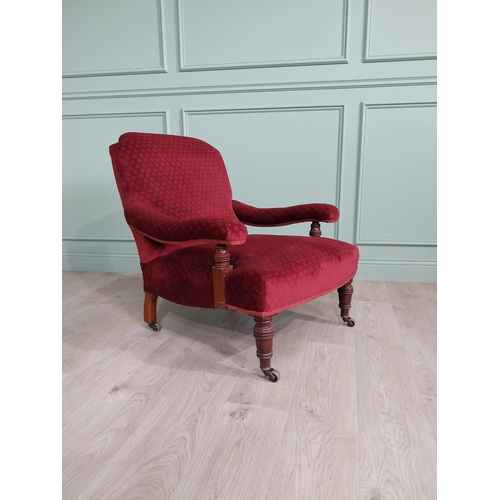 801 - 19th C. mahogany upholstered easy chair raised on turned legs and brass castors in the Howard and so... 