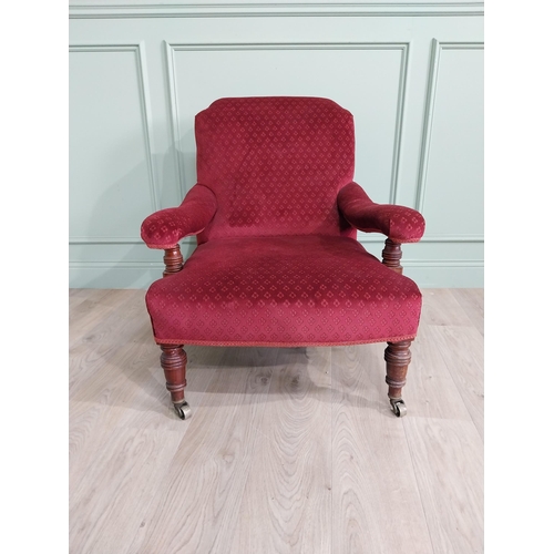 801 - 19th C. mahogany upholstered easy chair raised on turned legs and brass castors in the Howard and so... 