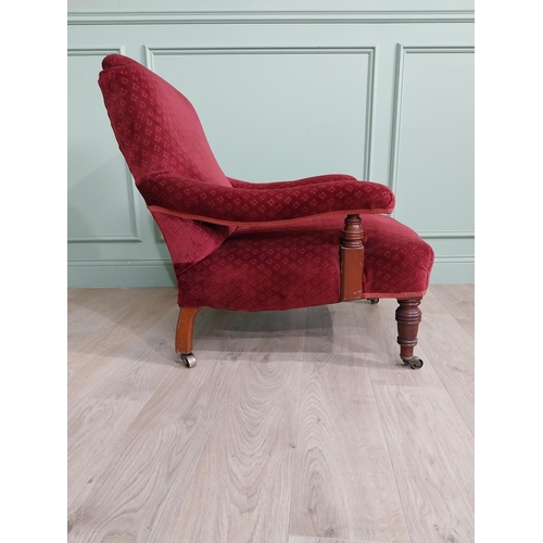 801 - 19th C. mahogany upholstered easy chair raised on turned legs and brass castors in the Howard and so... 