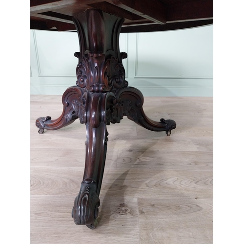 81 - Exceptional quality 19th C. rosewood centre table raised on profusely carved central pod and three o... 