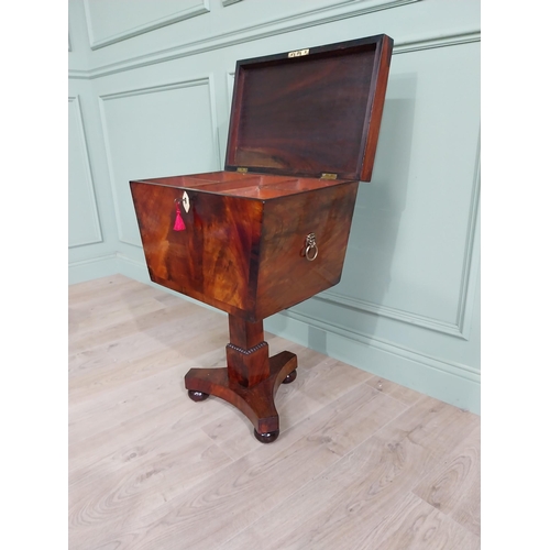 831 - Georgian flamed mahogany cellarette with fitted interior raised on square column and platform base {... 