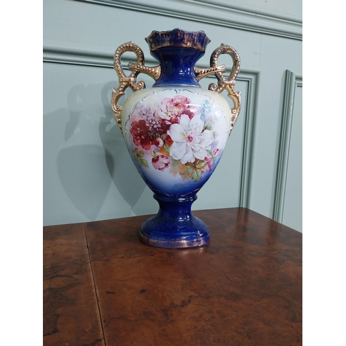 877 - Pair of ceramic vases with floral design and gilt handles {35 cm H x 24 cm W x 15 cm D}.