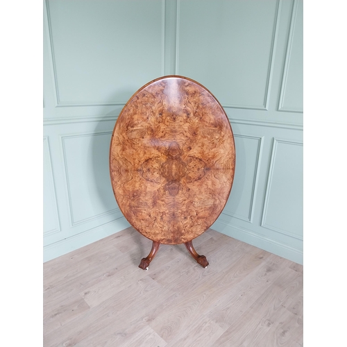 88 - Good quality Victorian burr walnut tilt top oval centre table raised on four columns, four out swept... 