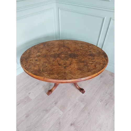 88 - Good quality Victorian burr walnut tilt top oval centre table raised on four columns, four out swept... 