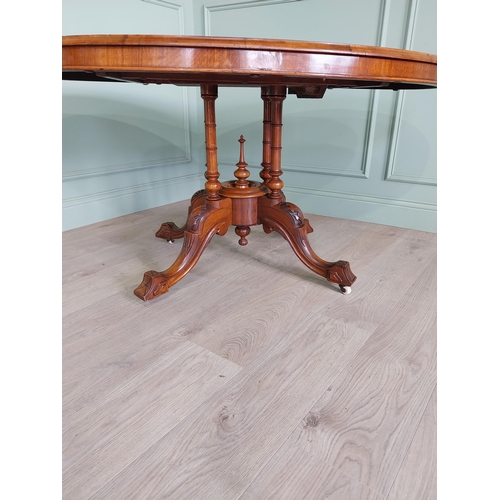 88 - Good quality Victorian burr walnut tilt top oval centre table raised on four columns, four out swept... 