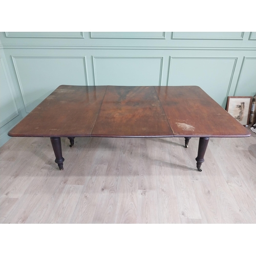 887 - Early 19th C. mahogany dining table raised on turned legs and brass castors {74 cm H x 194 cm W x 13... 