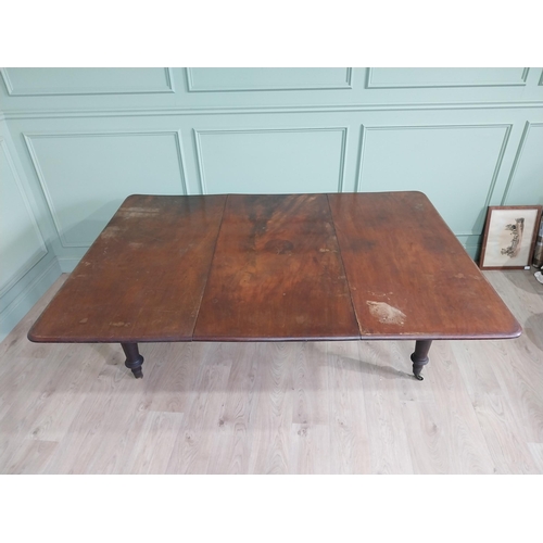 887 - Early 19th C. mahogany dining table raised on turned legs and brass castors {74 cm H x 194 cm W x 13... 