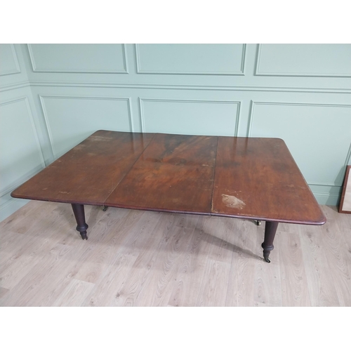 887 - Early 19th C. mahogany dining table raised on turned legs and brass castors {74 cm H x 194 cm W x 13... 