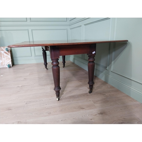 887 - Early 19th C. mahogany dining table raised on turned legs and brass castors {74 cm H x 194 cm W x 13... 