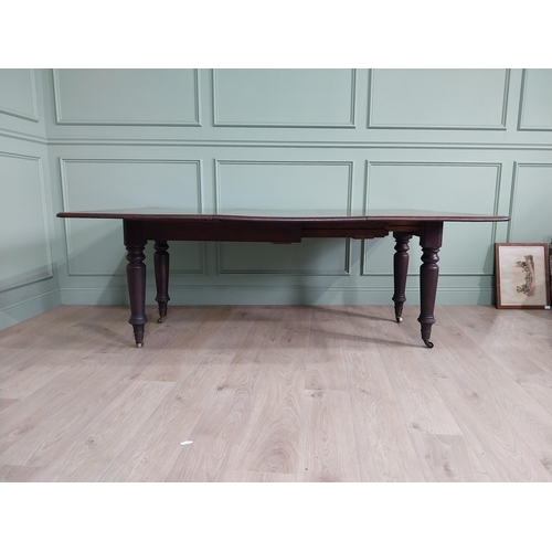 887 - Early 19th C. mahogany dining table raised on turned legs and brass castors {74 cm H x 194 cm W x 13... 